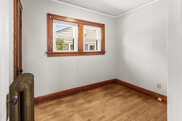 4648 S Kansas Ave Unit 4650, Saint Francis, WI 53235 - unfurnished room with radiator heating unit, baseboards, light wood-style floors, and ornamental molding