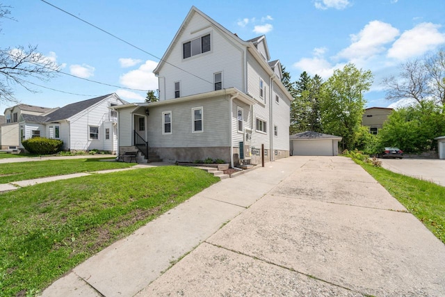 1925 Salisbury Rd, West Bend, WI 53090 - view of front of house with entry steps, an outdoor structure, a front lawn, and a garage