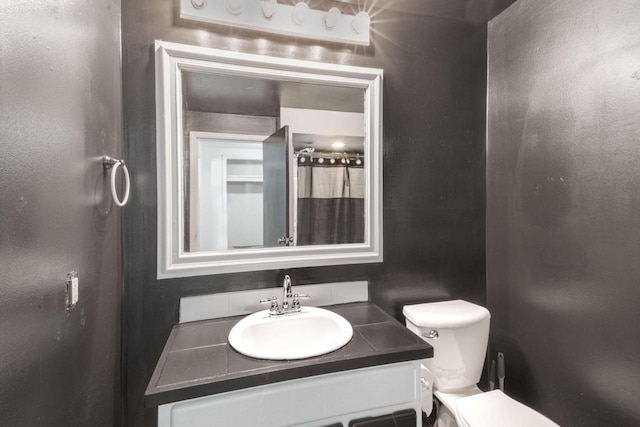 1925 Salisbury Rd, West Bend, WI 53090 - bathroom with vanity, toilet, and tasteful backsplash