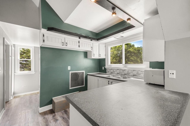 1925 Salisbury Rd, West Bend, WI 53090 - kitchen with a sink, white cabinets, dark countertops, and healthy amount of natural light