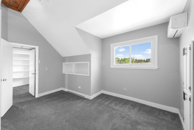 1925 Salisbury Rd, West Bend, WI 53090 - bonus room with a wall mounted air conditioner, dark carpet, baseboards, and lofted ceiling