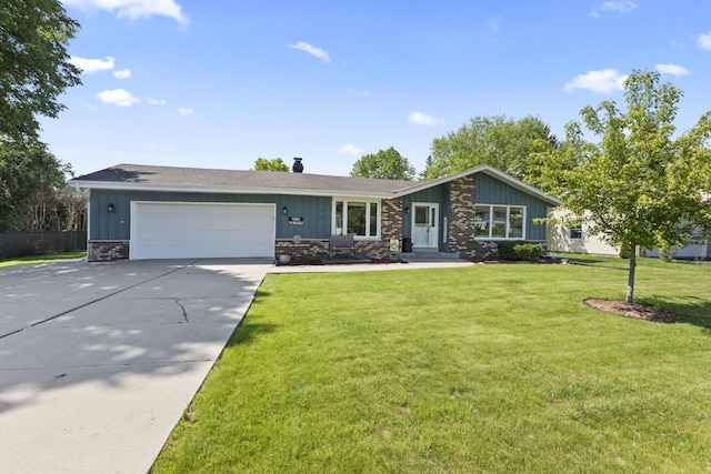 N101W16063 Santa Fe Dr, Germantown, WI 53022 - view of front of property with driveway, an attached garage, board and batten siding, and a front lawn