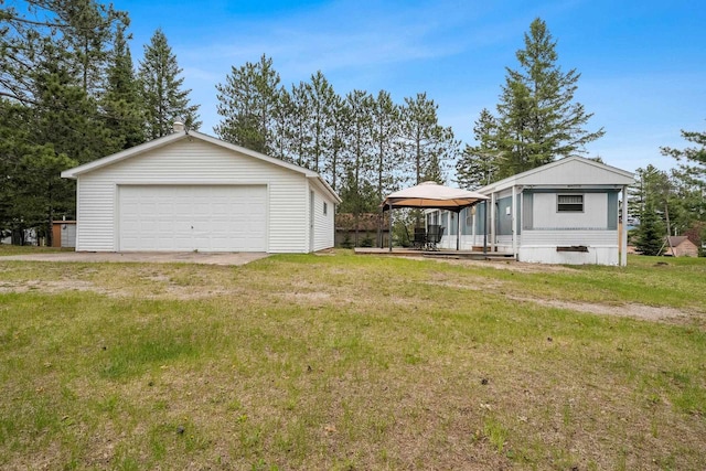 N9578 Dahleen Ln, Crivitz, WI 54114 - view of green lawn with a gazebo, a detached garage, and an outbuilding
