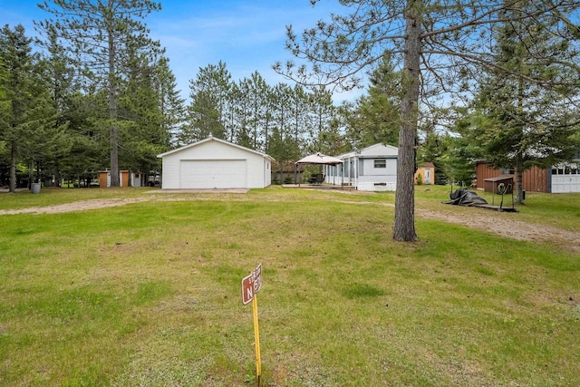 N9578 Dahleen Ln, Crivitz, WI 54114 - view of grassy yard featuring a garage and an outbuilding