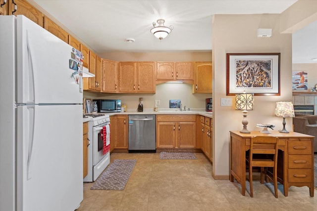 660 Wood River Ct Unit 1, West Bend, WI 53095 - kitchen with stainless steel appliances, light countertops, a sink, and under cabinet range hood