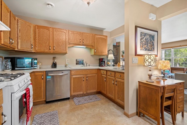 660 Wood River Ct Unit 1, West Bend, WI 53095 - kitchen featuring stainless steel appliances, a sink, light countertops, and light tile patterned floors