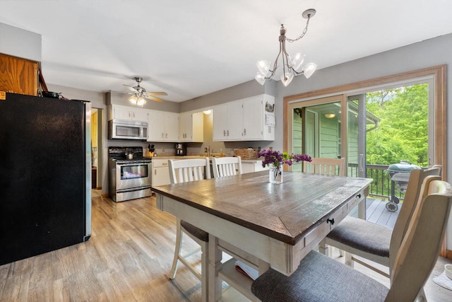 3324 County Highway Cc, Slinger, WI 53086 - dining room with light wood-type flooring, a chandelier, and a ceiling fan