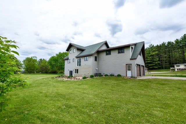 E3581 Green Valley Dr, La Valle, WI 53941 - view of property exterior featuring driveway, a lawn, and an attached garage
