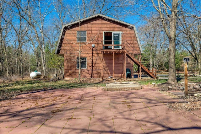 N9056 16th Ave, Neshkoro, WI 54960 - rear view of property with a gambrel roof, stairway, and a patio area