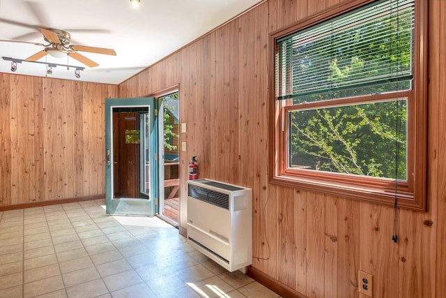 N9056 16th Ave, Neshkoro, WI 54960 - spare room with heating unit, wooden walls, a ceiling fan, and baseboards