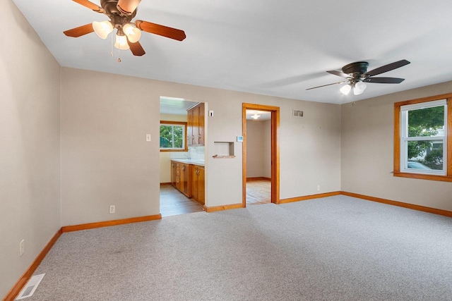 203 E 1st St, Kimberly, WI 54136 - empty room featuring light carpet, a ceiling fan, and baseboards