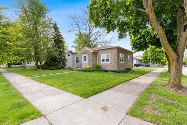 203 E 1st St, Kimberly, WI 54136 - view of front of home with stone siding and a front lawn