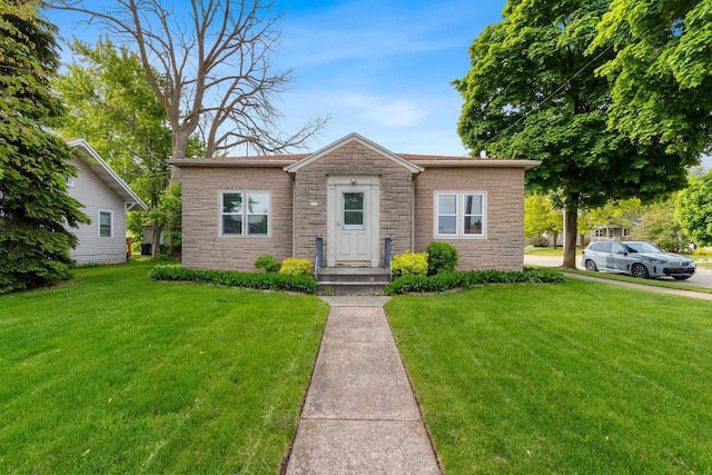 203 E 1st St, Kimberly, WI 54136 - bungalow featuring stone siding and a front lawn