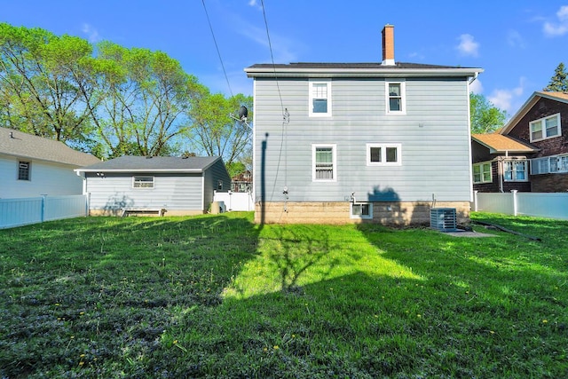 2254 N 73rd St, Wauwatosa, WI 53213 - rear view of house with central AC unit and a chimney