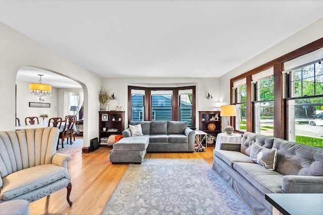 2254 N 73rd St, Wauwatosa, WI 53213 - living area with arched walkways, light wood-type flooring, and a chandelier