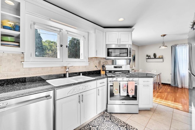 2254 N 73rd St, Wauwatosa, WI 53213 - kitchen featuring appliances with stainless steel finishes, a sink, white cabinets, healthy amount of natural light, and recessed lighting