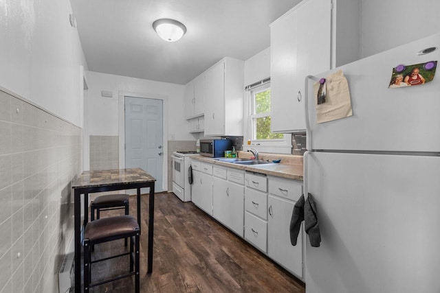 805 N State St, Appleton, WI 54911 - kitchen featuring white appliances, a sink, white cabinets, light countertops, and dark wood finished floors