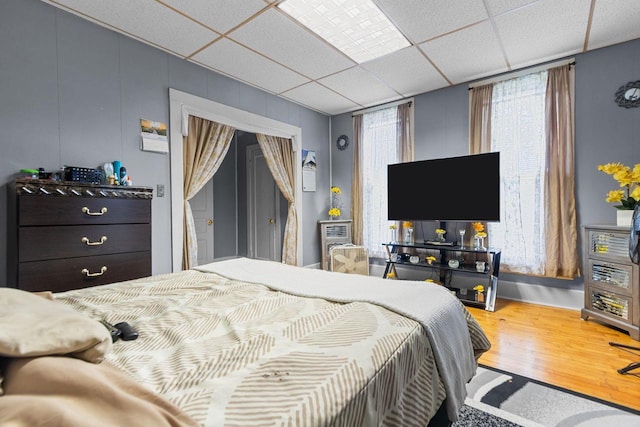 805 N State St, Appleton, WI 54911 - bedroom with wood finished floors, a paneled ceiling, and a decorative wall