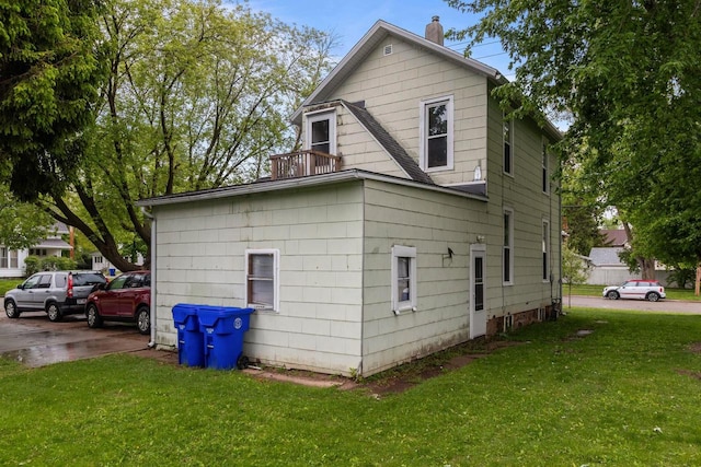 805 N State St, Appleton, WI 54911 - view of home's exterior with a balcony, a chimney, and a yard