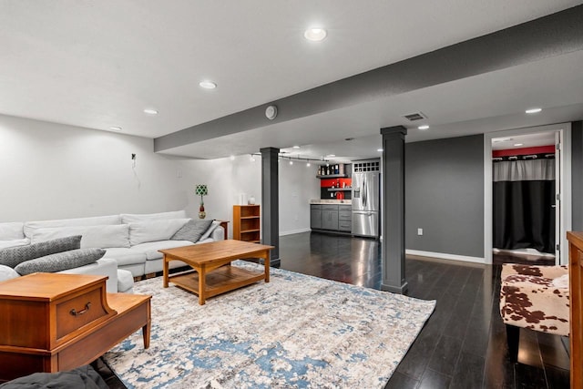 410 E Washington St, New London, WI 54961 - living area with bar area, baseboards, dark wood-style flooring, ornate columns, and recessed lighting