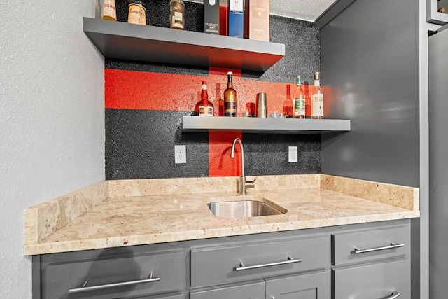 410 E Washington St, New London, WI 54961 - kitchen with gray cabinetry, open shelves, a sink, and a textured wall