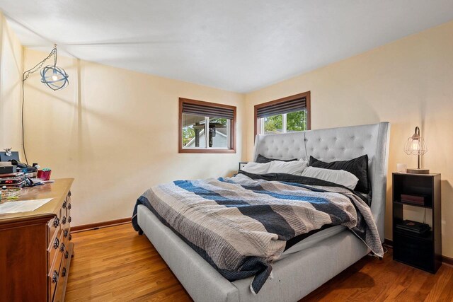 410 E Washington St, New London, WI 54961 - bedroom with light wood-type flooring and baseboards