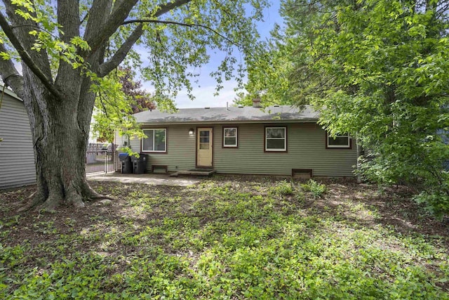 1054 Oxford Ct, Neenah, WI 54956 - rear view of property featuring a chimney