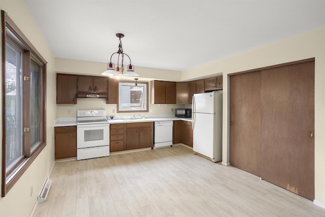1054 Oxford Ct, Neenah, WI 54956 - kitchen featuring white appliances, light countertops, under cabinet range hood, and a sink