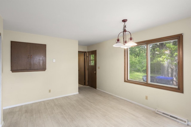 1054 Oxford Ct, Neenah, WI 54956 - spare room with light wood finished floors, baseboards, and baseboard heating