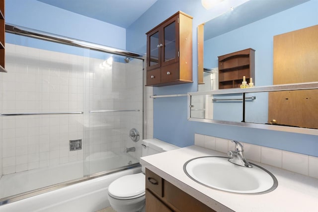 1054 Oxford Ct, Neenah, WI 54956 - bathroom featuring toilet, vanity, and shower / bath combination with glass door