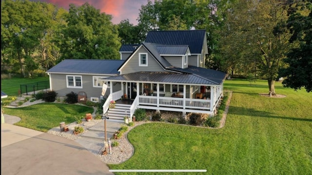 76 Hillside Rd, Edgerton, WI 53534 - farmhouse inspired home featuring covered porch, a front lawn, and metal roof