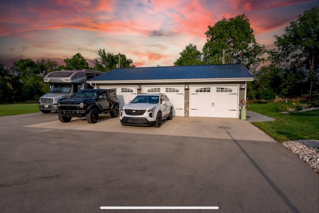 76 Hillside Rd, Edgerton, WI 53534 - view of front of home with concrete driveway, metal roof, and a front yard