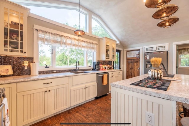 76 Hillside Rd, Edgerton, WI 53534 - kitchen featuring appliances with stainless steel finishes, a sink, vaulted ceiling, backsplash, and dark wood-style floors