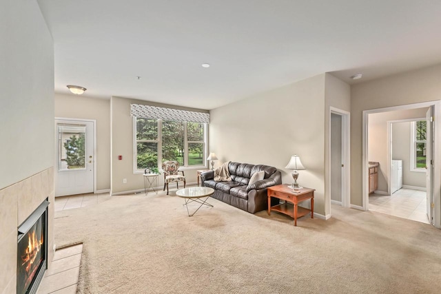 8687 S Deerwood Ln, Franklin, WI 53132 - living room with light colored carpet, baseboards, and a tiled fireplace