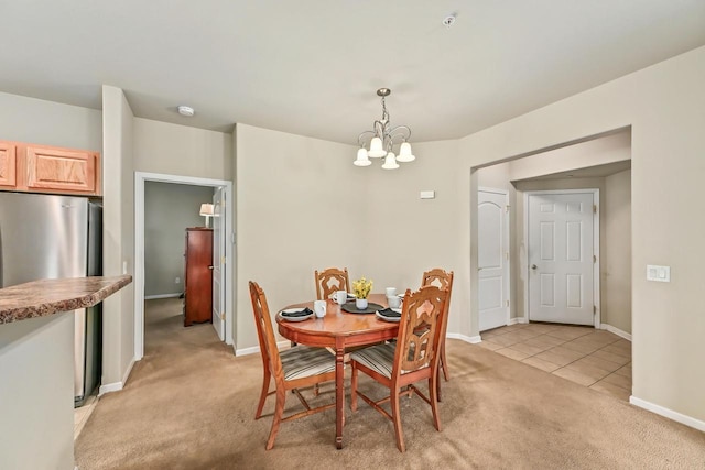 8687 S Deerwood Ln, Franklin, WI 53132 - dining space featuring light colored carpet, a chandelier, baseboards, and light tile patterned floors
