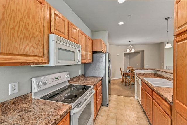 8687 S Deerwood Ln, Franklin, WI 53132 - kitchen featuring white appliances, a sink, pendant lighting, a chandelier, and light tile patterned flooring