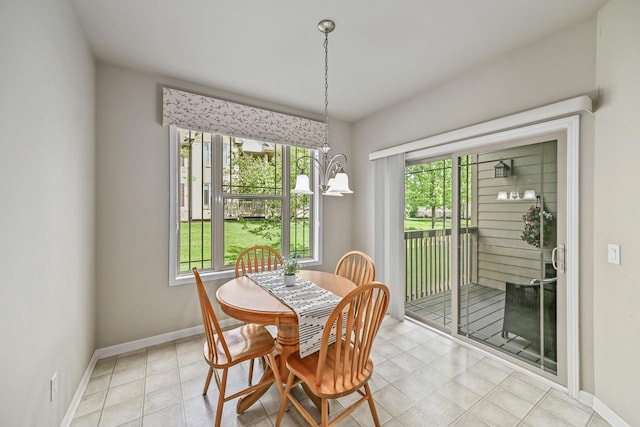 8687 S Deerwood Ln, Franklin, WI 53132 - dining area with baseboards, a chandelier, and light tile patterned flooring