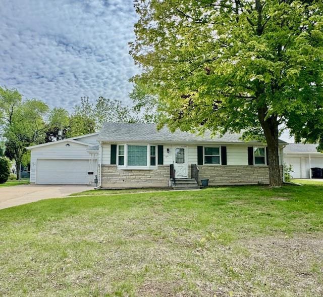 166 Gwynn St, Green Bay, WI 54301 - ranch-style home with stone siding, a garage, concrete driveway, and a front lawn