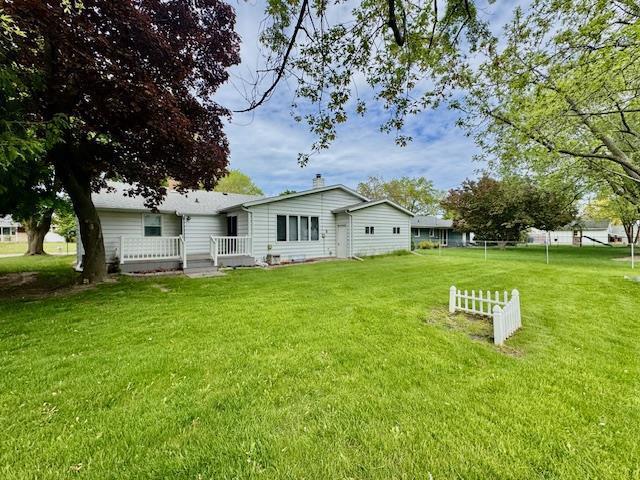166 Gwynn St, Green Bay, WI 54301 - rear view of property featuring a lawn