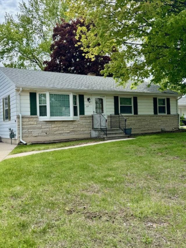 166 Gwynn St, Green Bay, WI 54301 - ranch-style house featuring stone siding, a front yard, and a shingled roof