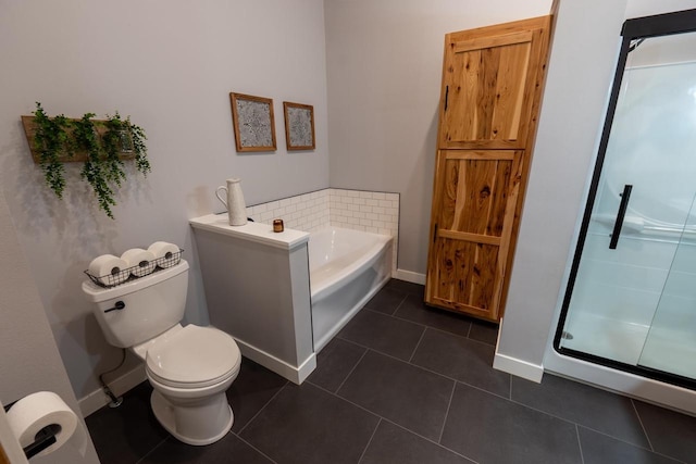 S1579 Butler Rd, Hillsboro, WI 54634 - bathroom featuring toilet, a bath, tile patterned floors, a stall shower, and baseboards
