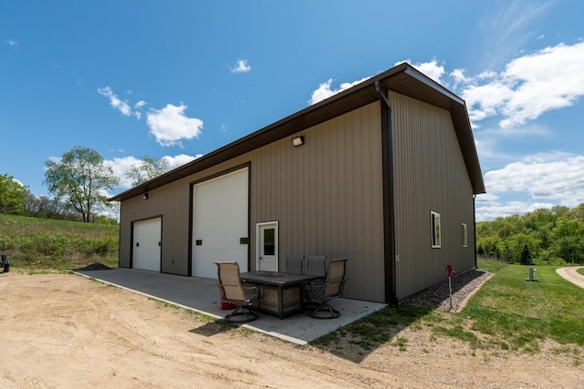 S1579 Butler Rd, Hillsboro, WI 54634 - view of property exterior featuring a garage, an outbuilding, and a patio