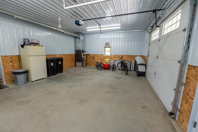 S1579 Butler Rd, Hillsboro, WI 54634 - garage featuring freestanding refrigerator and a garage door opener