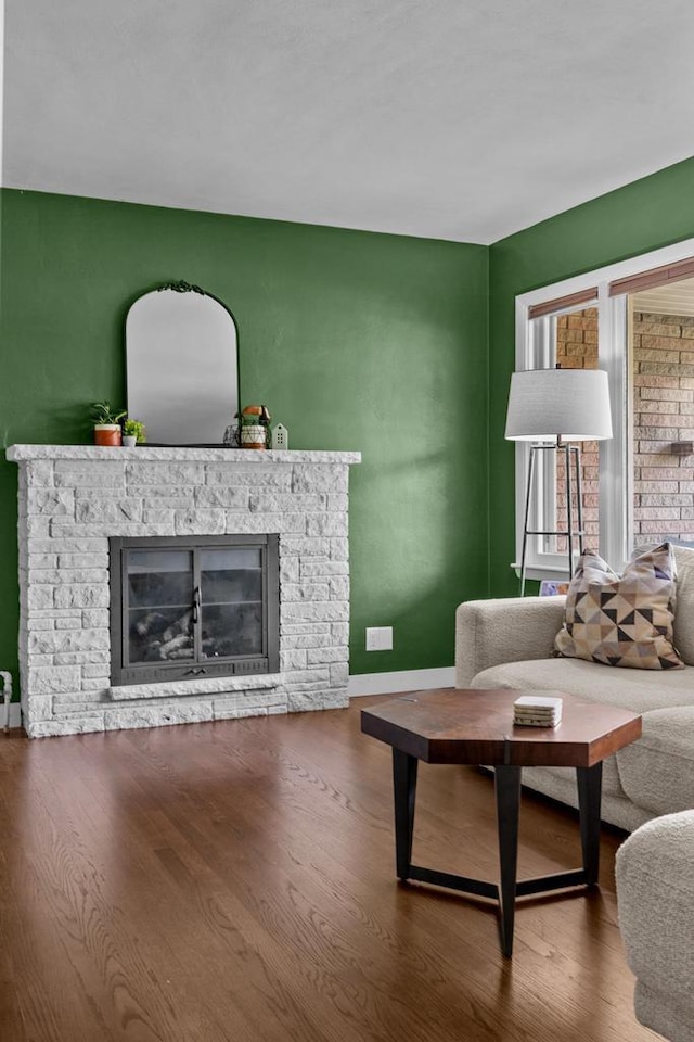 751 Warsaw St, Menasha, WI 54952 - living area featuring a fireplace, wood finished floors, and baseboards