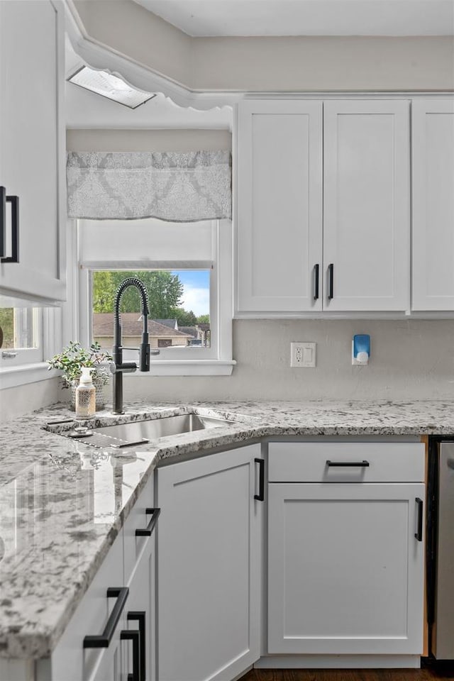 751 Warsaw St, Menasha, WI 54952 - kitchen with a sink, white cabinets, light stone counters, and dishwashing machine