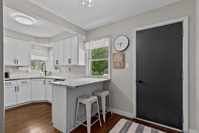 751 Warsaw St, Menasha, WI 54952 - kitchen with white cabinets, dark wood finished floors, and light stone countertops