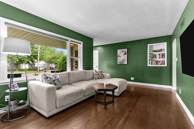 751 Warsaw St, Menasha, WI 54952 - living room featuring dark wood-style floors, built in shelves, and baseboards