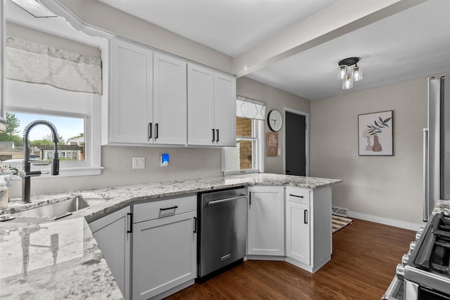 751 Warsaw St, Menasha, WI 54952 - kitchen featuring a sink, stainless steel appliances, a peninsula, plenty of natural light, and beamed ceiling