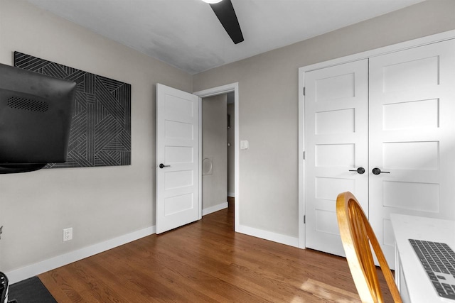 751 Warsaw St, Menasha, WI 54952 - unfurnished bedroom with baseboards, wood finished floors, ceiling fan, and a closet