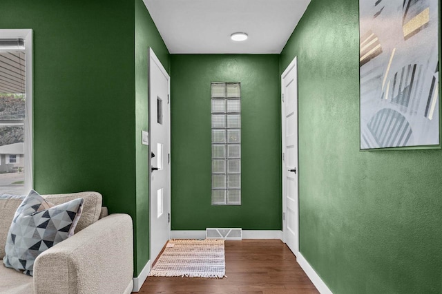 751 Warsaw St, Menasha, WI 54952 - entryway featuring wood finished floors, baseboards, healthy amount of natural light, and a textured wall